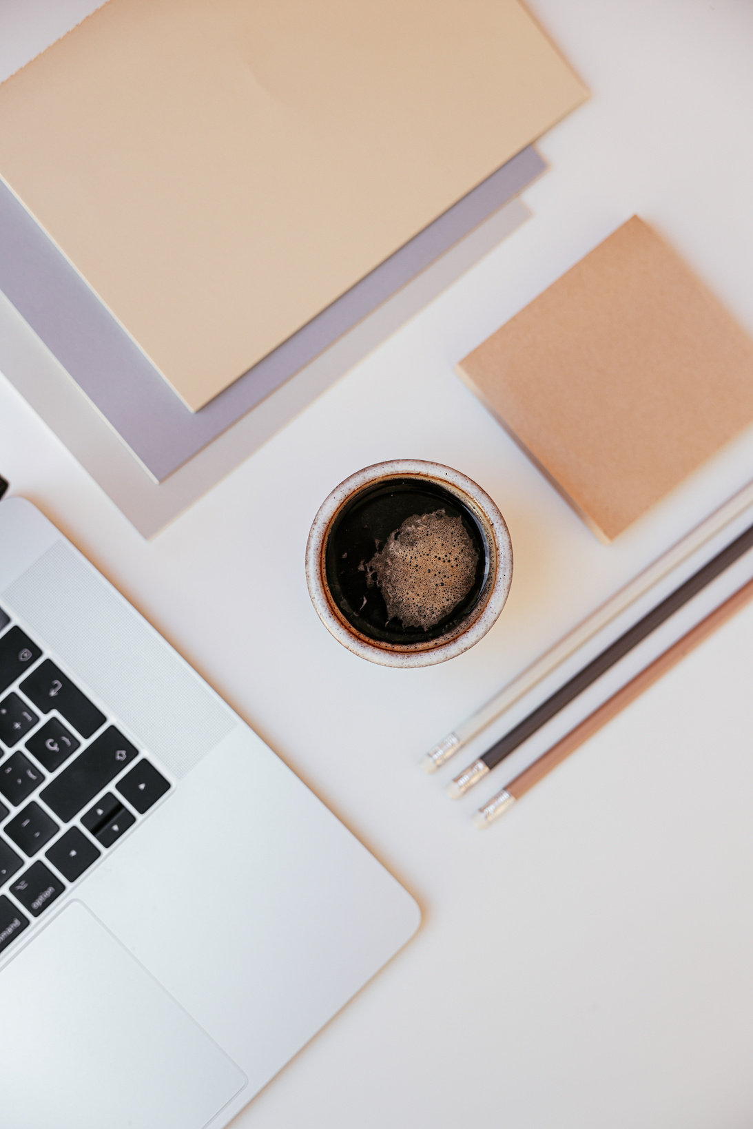 Macbook Air Beside Brown Notebook